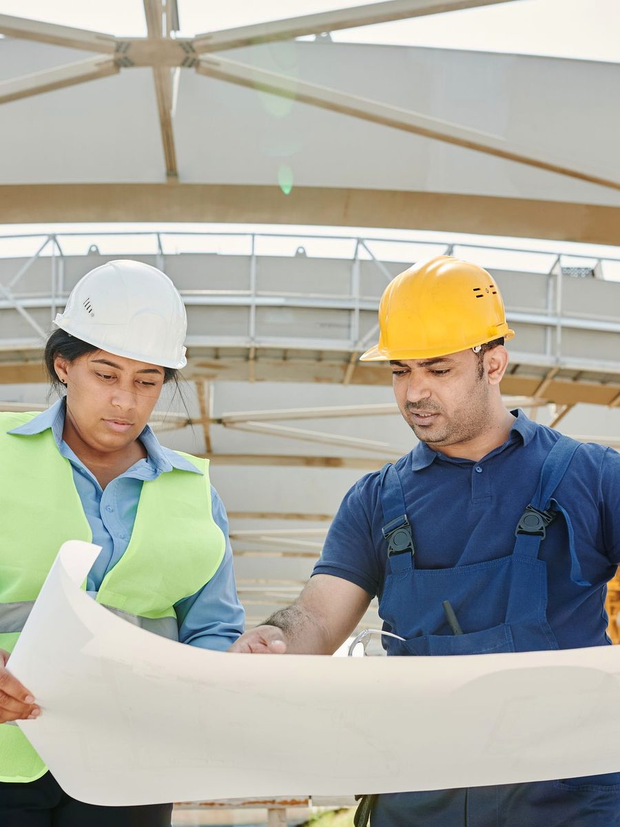 Site engineer and foreman reviewing drawings on site