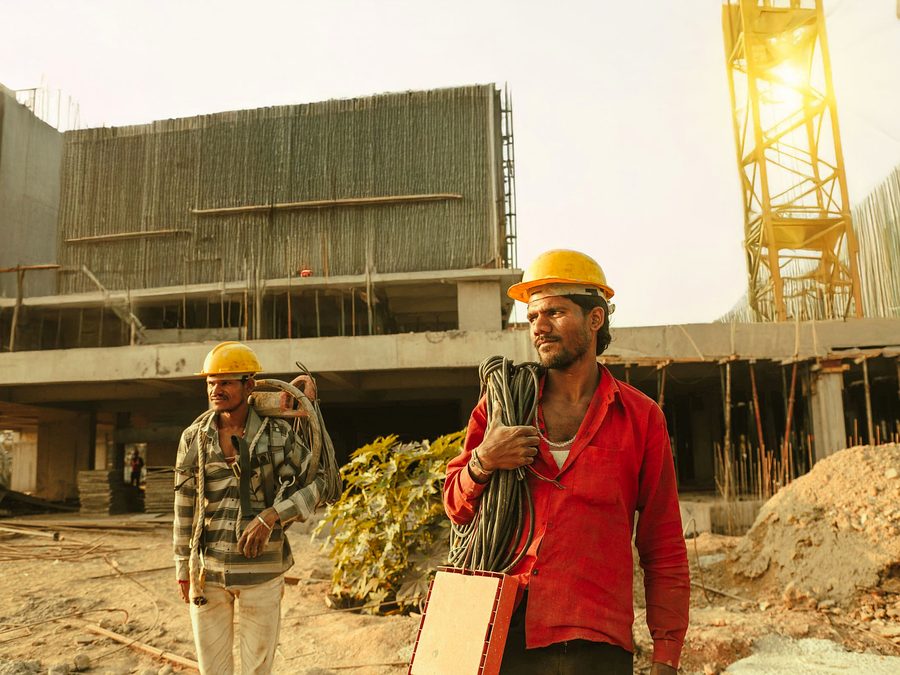 Construction workers crossing a site at the end of a shift