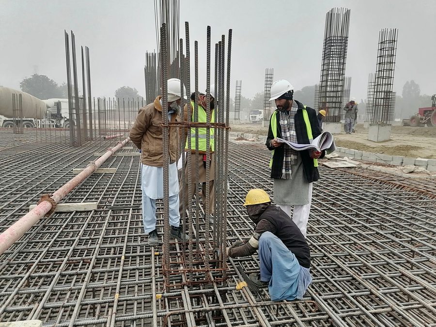 Steel fixing crew working over a reinforcement mat