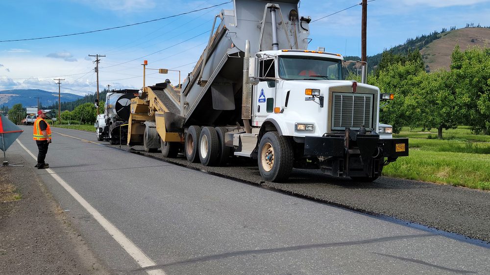 Road crew laying a new pavement layer